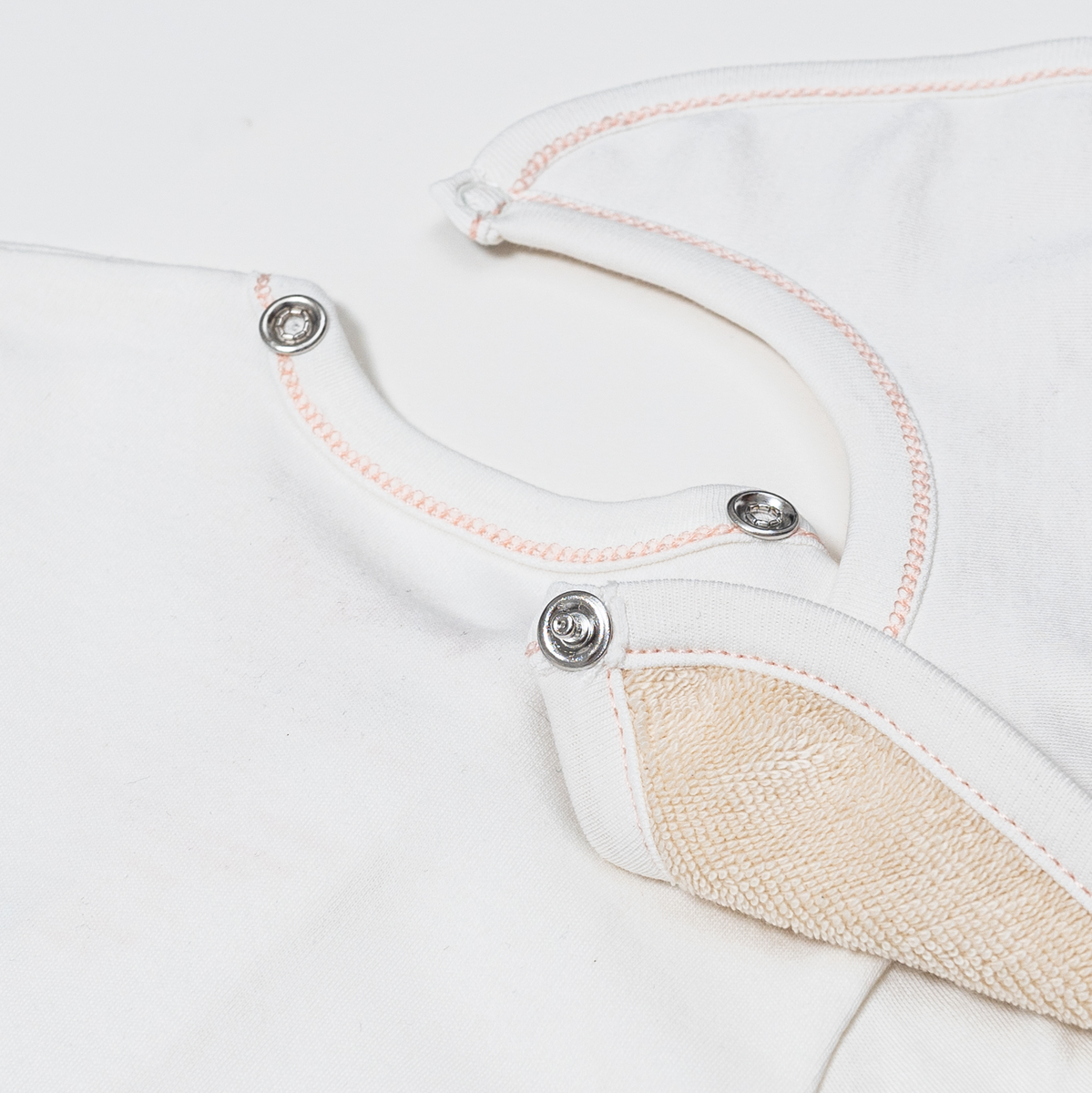 The Babysuit - Detail showing bib snap directly on to babysuit